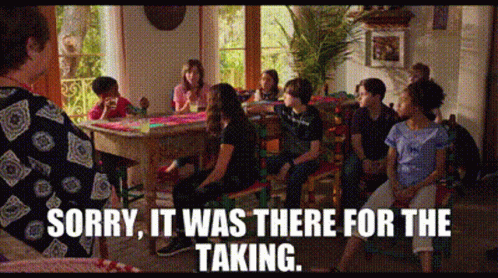 A Group Of People Are Sitting Around A Table With The Words Sorry It Was There For The Taking On The Bottom GIF