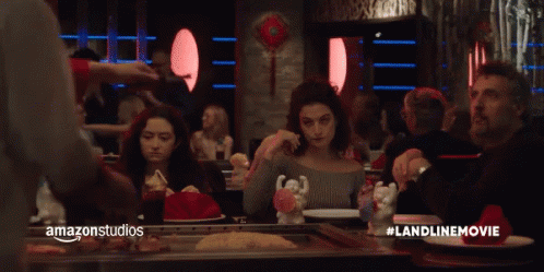 A Group Of People Are Sitting At A Table In A Restaurant With Amazonstudios Written On The Bottom Right GIF