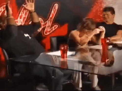 A Group Of People Are Sitting At A Table With Coca Cola Bottles On It GIF
