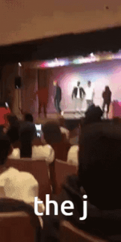 Audience Watching Stage With J Sign GIF