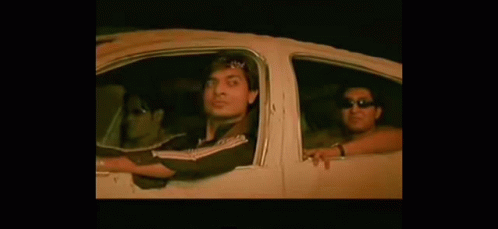 A Group Of People Are Sitting In A Car With Their Arms Out The Window . GIF