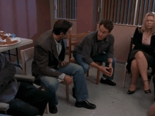 A Group Of People Are Sitting In A Circle And Talking GIF