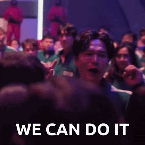 A Group Of People Are Sitting In A Dark Room And A Man Is Screaming In The Middle Of The Crowd . GIF