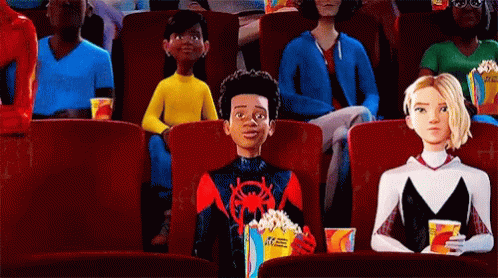 A Group Of People Are Sitting In A Movie Theater Watching A Movie . GIF