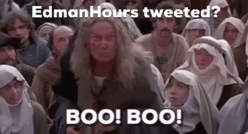 A Group Of People Are Sitting In A Room And A Woman Is Standing In Front Of Them . GIF