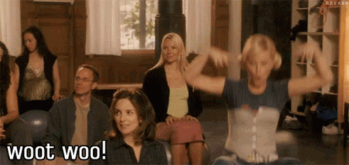 a group of people are sitting in a room and one of them is saying woot woo .