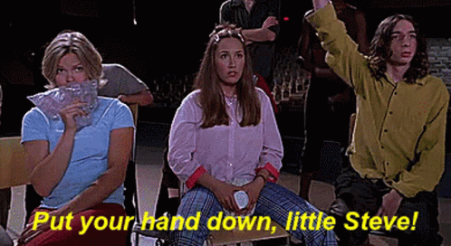 A Group Of People Are Sitting In A Room With The Words `` Put Your Hand Down , Little Steve '' . GIF