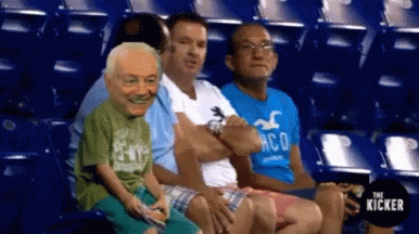 A Group Of People Are Sitting In A Stadium And One Of Them Is Wearing A Hollister Shirt . GIF