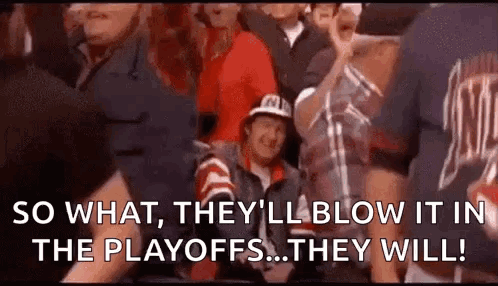 A Group Of People Are Sitting In A Stadium Watching A Game And A Man Is Sitting In The Stands . GIF