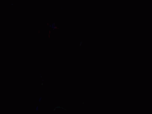 A Group Of People Are Sitting In A Stadium With Their Arms In The Air And A Boy In A Green Shirt . GIF