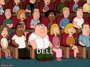 A Group Of People Are Sitting In A Theater And One Of Them Is Kneeling Down And Saying Dell GIF