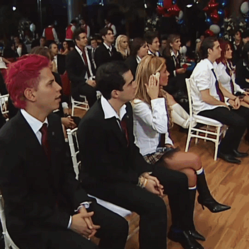 a group of people are sitting in chairs watching a presentation