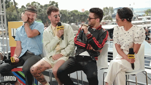 A Group Of People Are Sitting In Front Of A Microphone That Says Imdb GIF