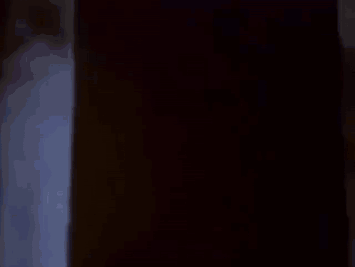 A Group Of People Are Sitting In Front Of A Projector Screen Watching A Cartoon . GIF