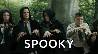 A Group Of People Are Sitting Next To Each Other In Front Of A Tree With The Word Spooky Written On The Bottom . GIF