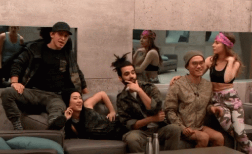 A Group Of People Are Sitting On A Couch And One Of Them Is Wearing A Headband GIF