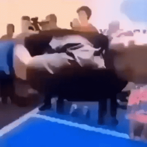 A Group Of People Are Sitting On A Couch In Front Of A Swimming Pool . GIF