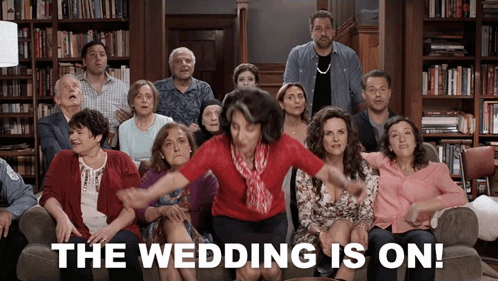 A Group Of People Are Sitting On A Couch With The Words The Wedding Is On GIF