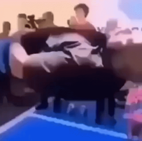 A Group Of People Are Sitting On A Couch . GIF