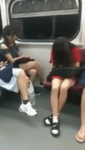A Group Of People Are Sitting On A Subway Train GIF