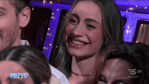A Group Of People Are Smiling In Front Of A Screen That Says 5 Hd On It GIF