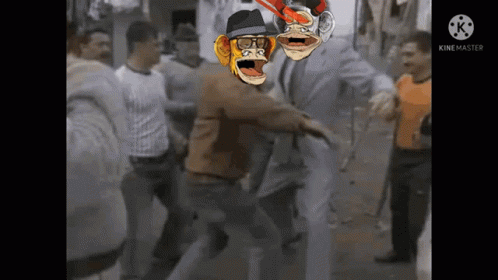 A Group Of People Are Standing Around A Man With A Monkey On His Head GIF