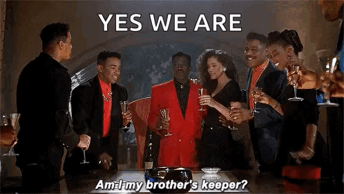 A Group Of People Are Standing Around A Table Holding Champagne Glasses And A Man In A Red Suit Is Saying Yes We Are . GIF