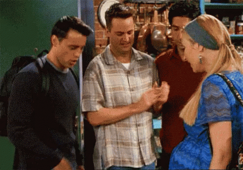 A Group Of People Are Standing Around A Woman In A Blue Dress And Talking To Each Other . GIF