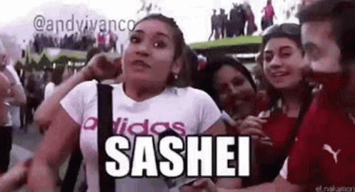 A Group Of People Are Standing Around A Woman In A White T-Shirt . GIF