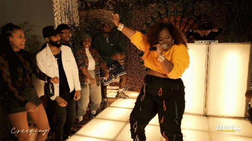 A Group Of People Are Standing Around A Woman On A Dance Floor With Creeping Written On The Bottom GIF