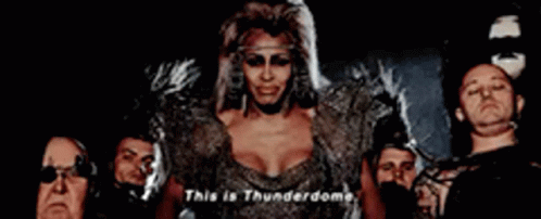 A Group Of People Are Standing Around A Woman Who Says This Is Thunderdome . GIF