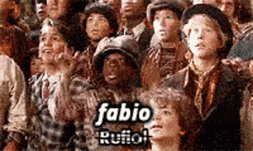 A Group Of People Are Standing In A Crowd With The Name Fabio Rufo On The Bottom GIF