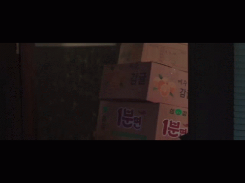 A Group Of People Are Standing In A Dark Room With A Sign That Says ' I 'M Sorry ' On It GIF