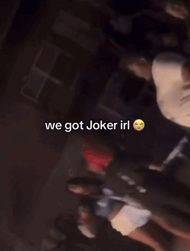 A Group Of People Are Standing In A Dark Room With The Words We Got Joker Irl On The Bottom GIF
