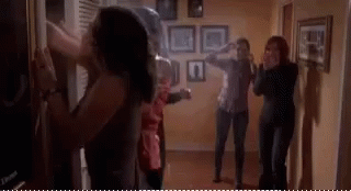People Standing In Hallway Looking At Each Other GIF