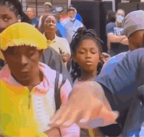 A Group Of People Are Standing In A Line Including A Girl Wearing A Yellow Hat GIF