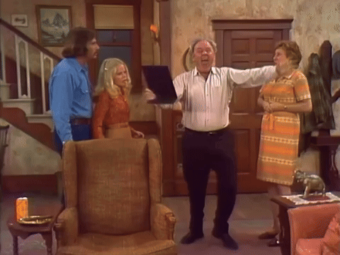 People Standing In Living Room With Man Holding Paper GIF