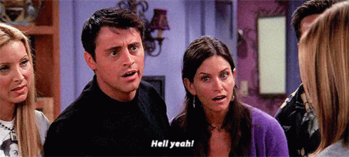 A Group Of People Are Standing In A Room And One Of Them Is Saying " Hell Yeah " GIF