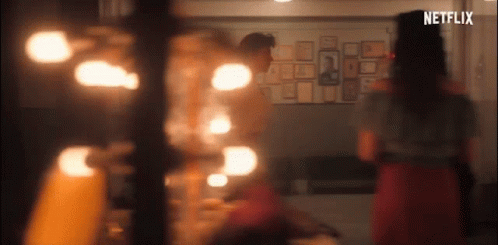 A Group Of People Are Standing In A Room With A Netflix Logo On The Bottom Of The Screen . GIF