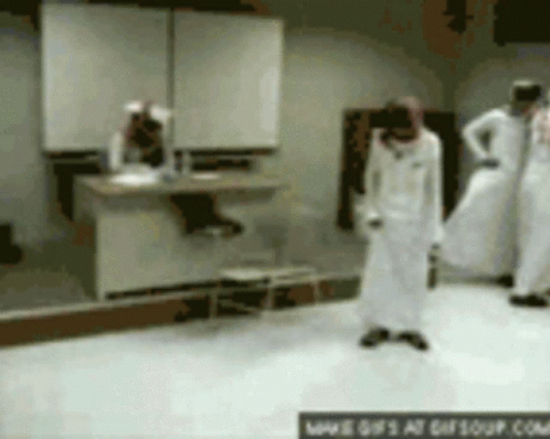 A Group Of People Are Standing In A Room With A Sign That Says ' Www.gifsoup.com ' On The Bottom GIF