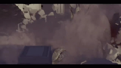 A Group Of People Are Standing In A Room With Smoke Coming Out Of The Walls . GIF