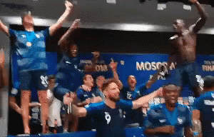 A Group Of People Are Standing In A Room With The Word Moscow On The Wall . GIF
