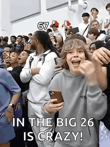 A Group Of People Are Standing In A Room With The Words In The Big 26 Is Crazy Written On The Bottom GIF