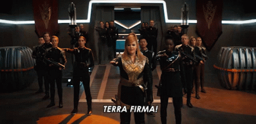A Group Of People Are Standing In A Room With The Words Terra Firma On The Floor GIF