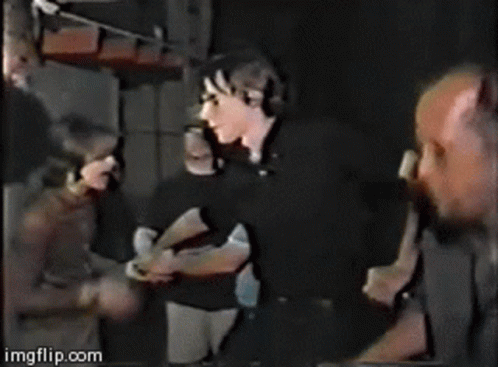 Group Of People Standing With Weezer Text GIF