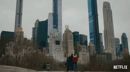 a group of people are standing in front of a city skyline with a netflix logo in the corner