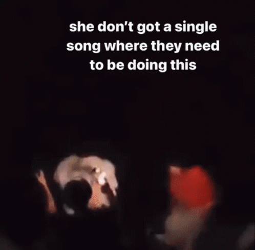 A Group Of People Are Standing In Front Of A Crowd Holding Their Phones In The Air . GIF