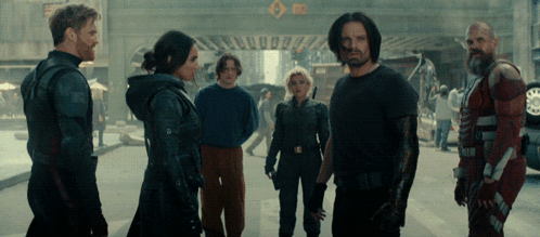 Group Standing In Front Of Sign A GIF