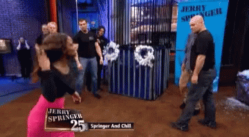 A Group Of People Are Standing In Front Of A Sign That Says Jerry Springer 25 GIF