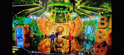 A Group Of People Are Standing In Front Of A Stage That Has A Big B On It GIF